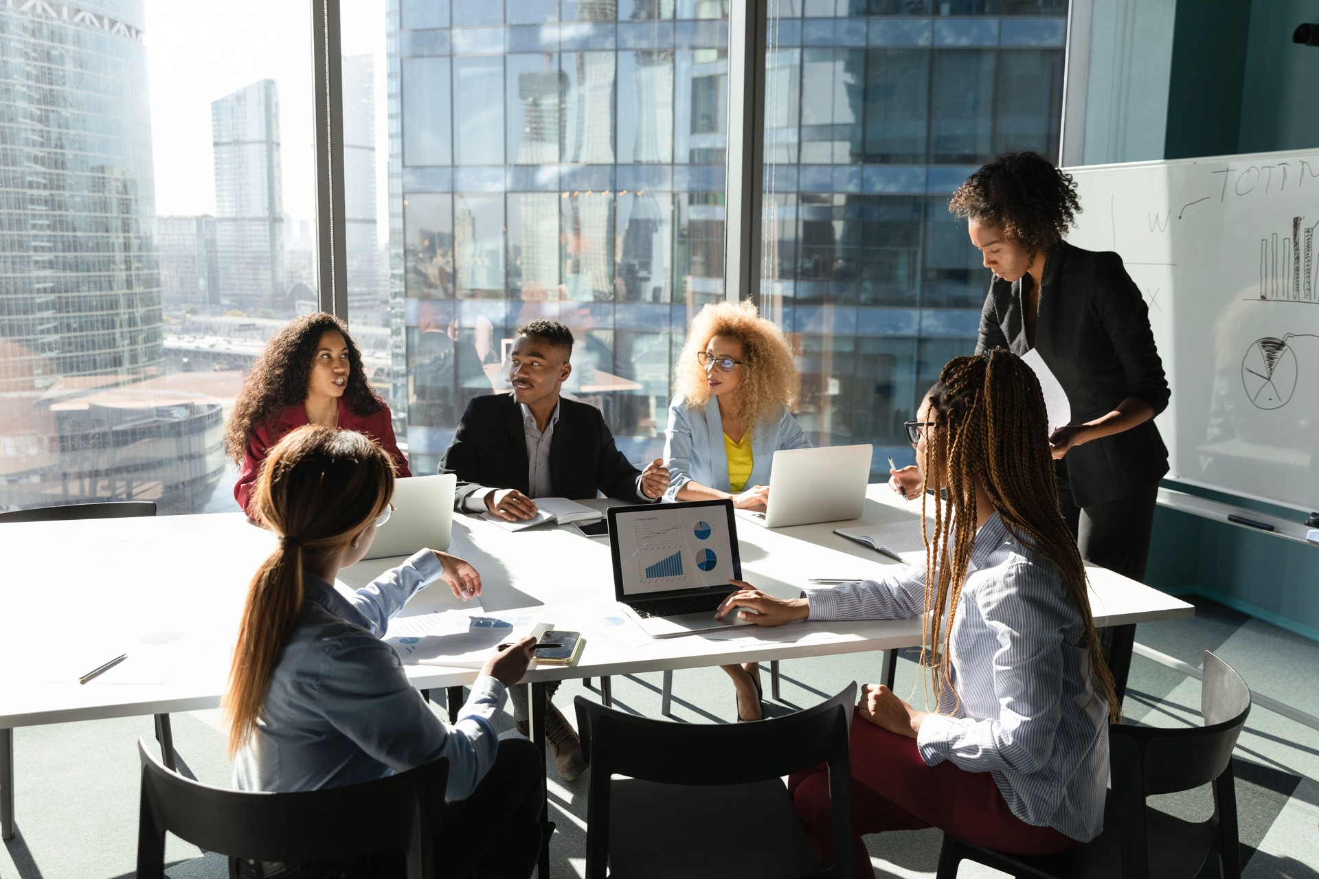 African American business people brainstorming at corporate meeting, discussing project